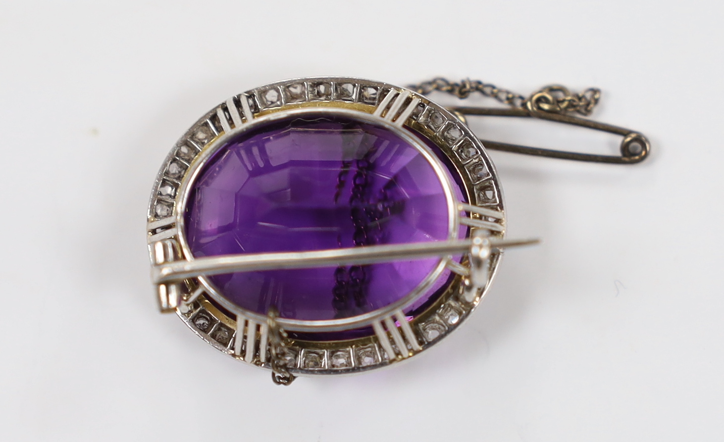 An early 20th century yellow and white metal, amethyst and rose cut diamond set oval cluster set brooch, 26mm, gross weight 11.2 grams.